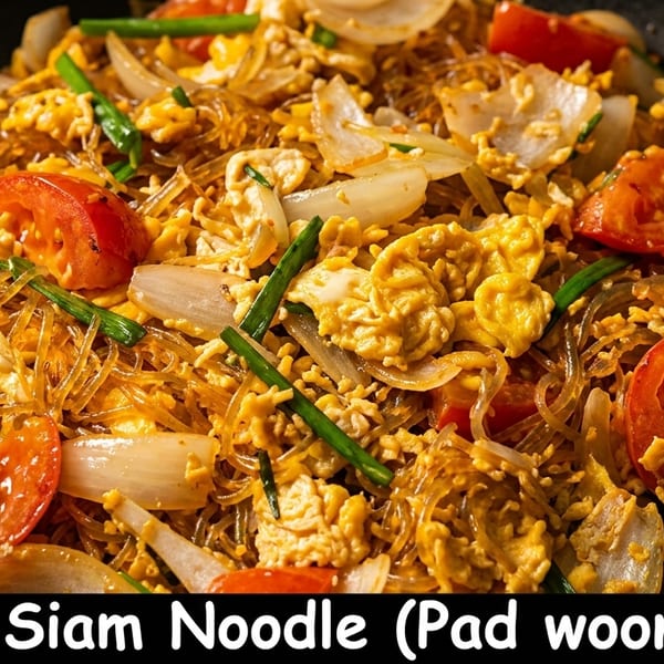 Siam Noodle (Pad Woonsen) with glass noodles, scrambled egg, tomatoes, onions, and green onions.